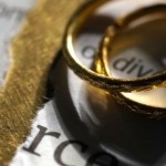 Wedding rings over a newspaper article regarding divorce.